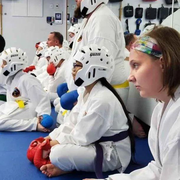 Group of students in sparring gear ready for tournament practice
