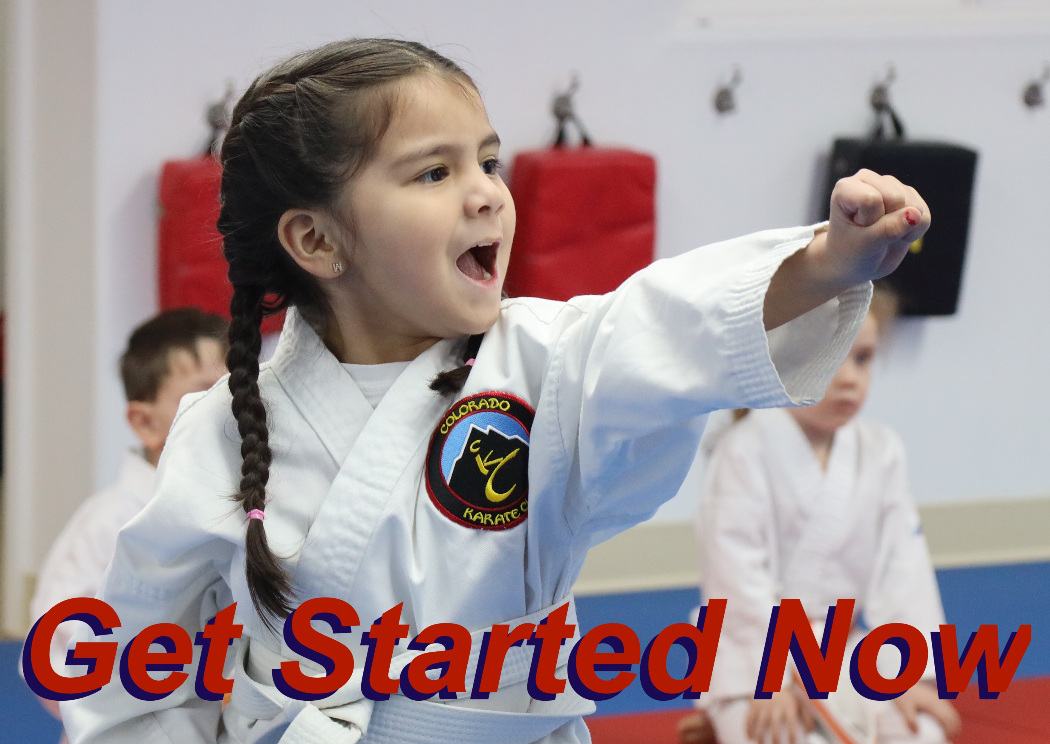 Young karate student throwing a powerful punch with fierce joy during class